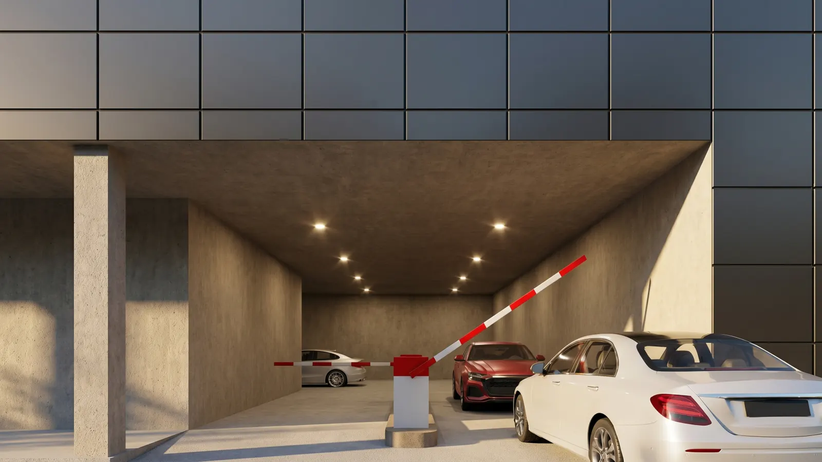 The vehicle entrance — a sedan at the raised barrier beneath the lit portal