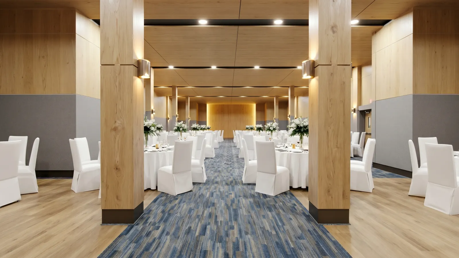 The event hall dressed for a function — round banquet tables between timber columns